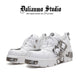White lace-up platform shoes with chunky sole and silver buckle straps