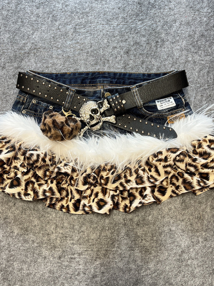 Leopard print denim skirt with white faux fur trim and black studded belt, heart pendant