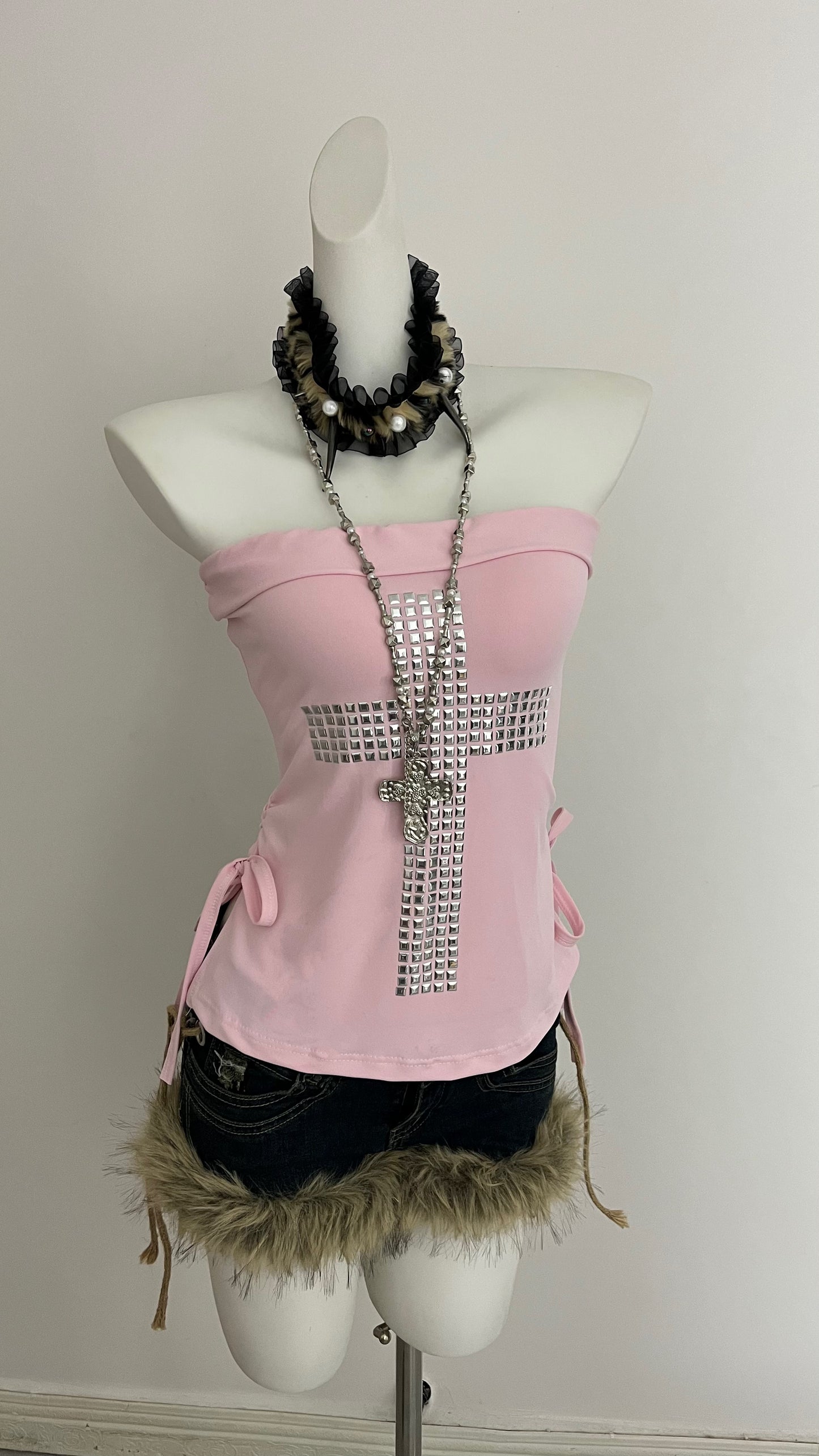 Pink strapless corset top with rhinestone cross detail and dangling chains