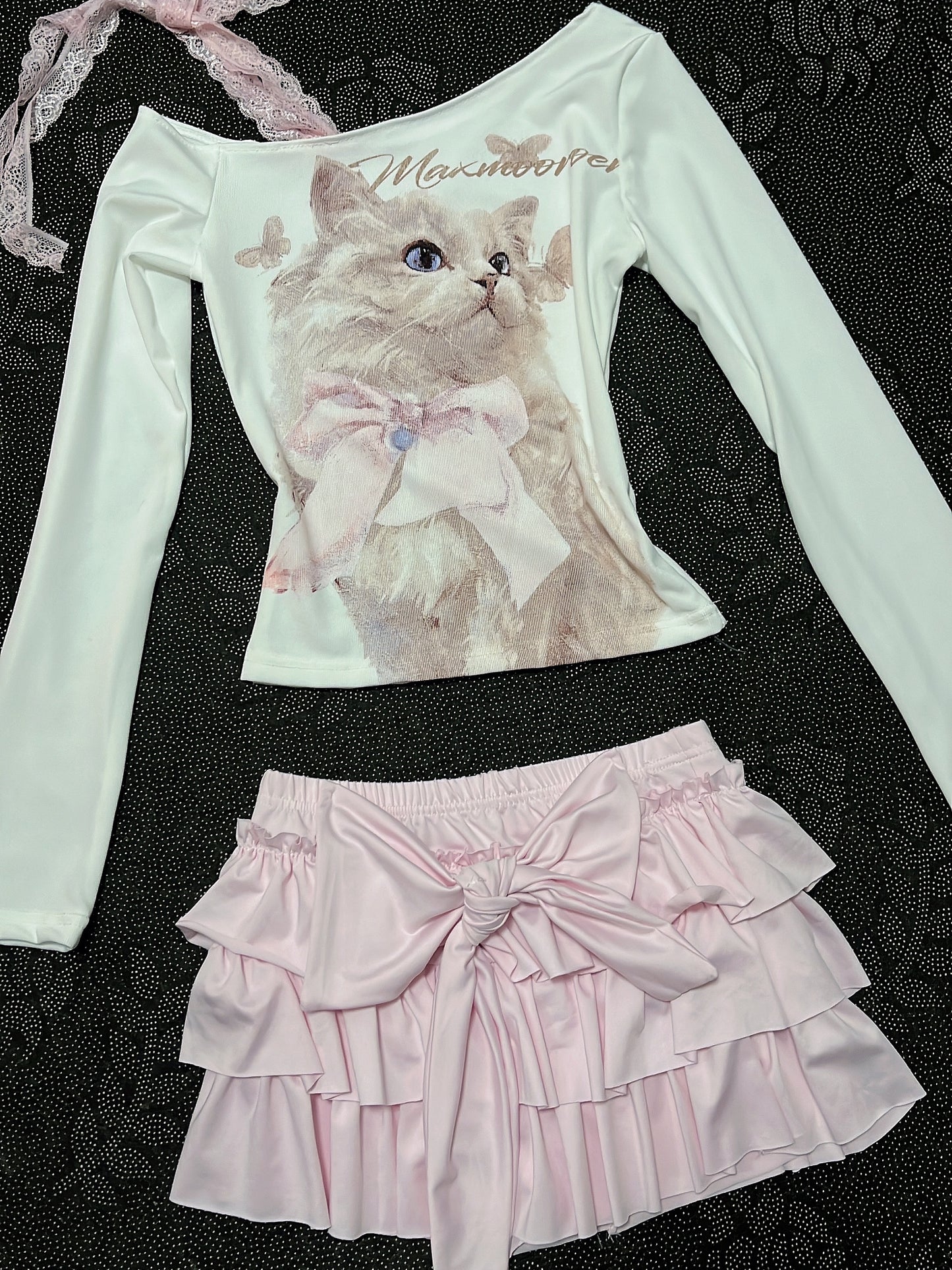Cream long-sleeve cat top with lace-trim strap and pale pink tiered ruffle skirt