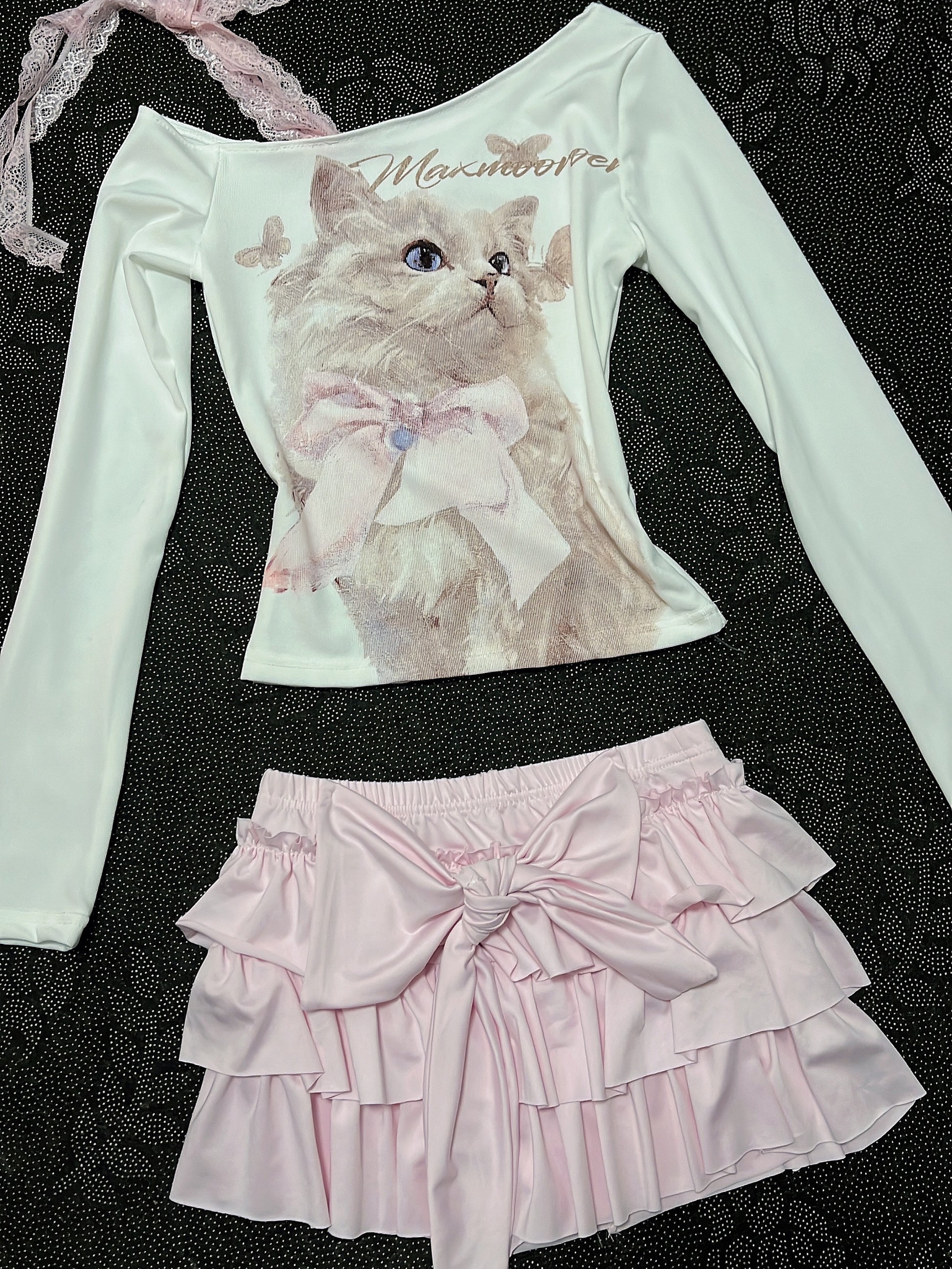 Cream long-sleeve cat top with lace-trim strap and pale pink tiered ruffle skirt
