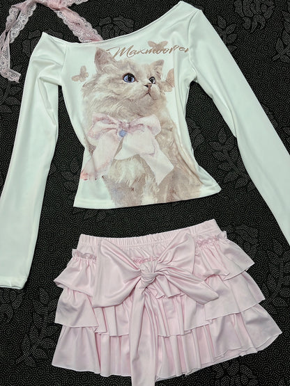 Cream long-sleeve cat top with lace-trim strap and pale pink tiered ruffle skirt