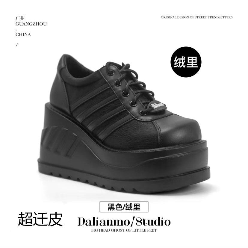 Black platform shoes with lace-up front, double straps, and chunky lug sole