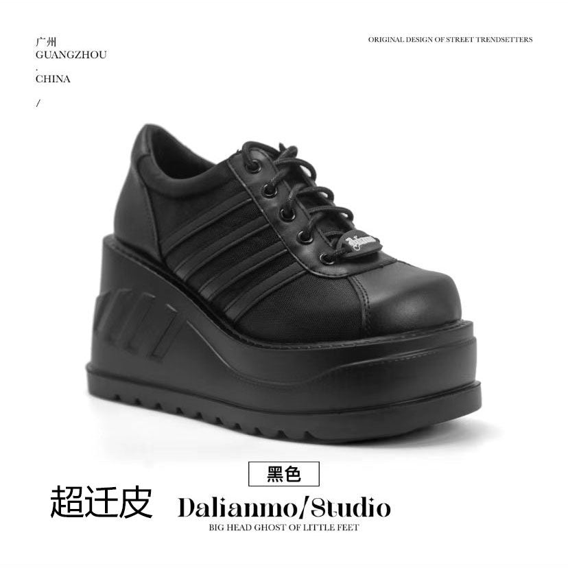 Black lace-up platform shoes with chunky tread sole and stitched panel lines