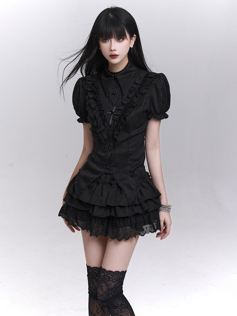 Black puff-sleeve blouse with textured front and tiered ruffle hem