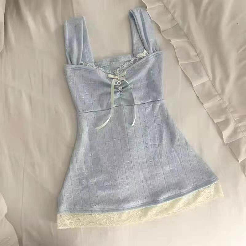 Light blue denim pinafore mini dress with button front and ruffled hem
