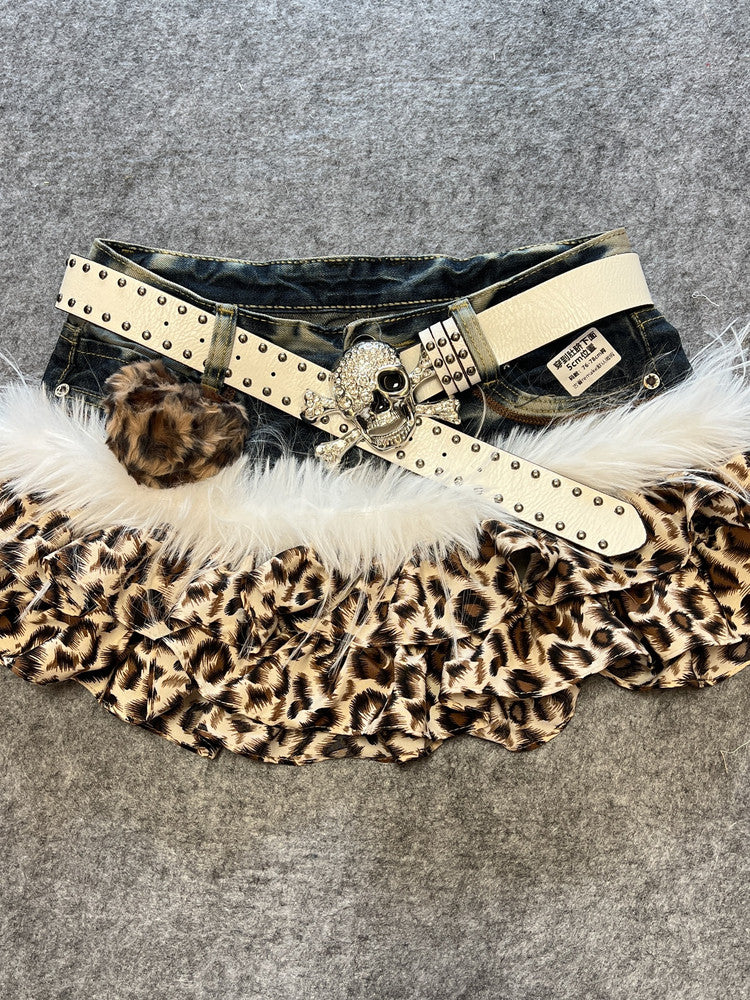Leopard print denim skirt with white faux fur trim and beige studded belt, heart pendant
