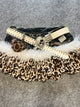 Leopard print denim skirt with white faux fur trim and beige studded belt, heart pendant