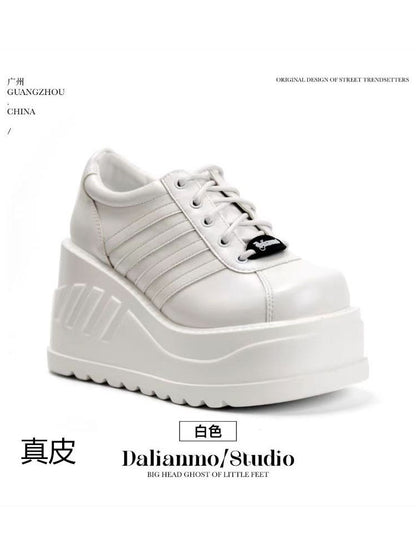 White platform shoes with lace-up front, stitched panel stripes, and thick tread sole