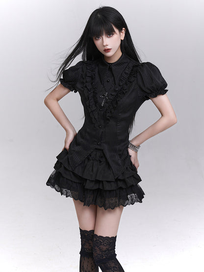 Black blouse with high neck, button-front details, and layered ruffle hem