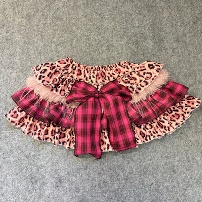 Puffy mini skirt in pink leopard and plaid layers with faux fur trim and bow