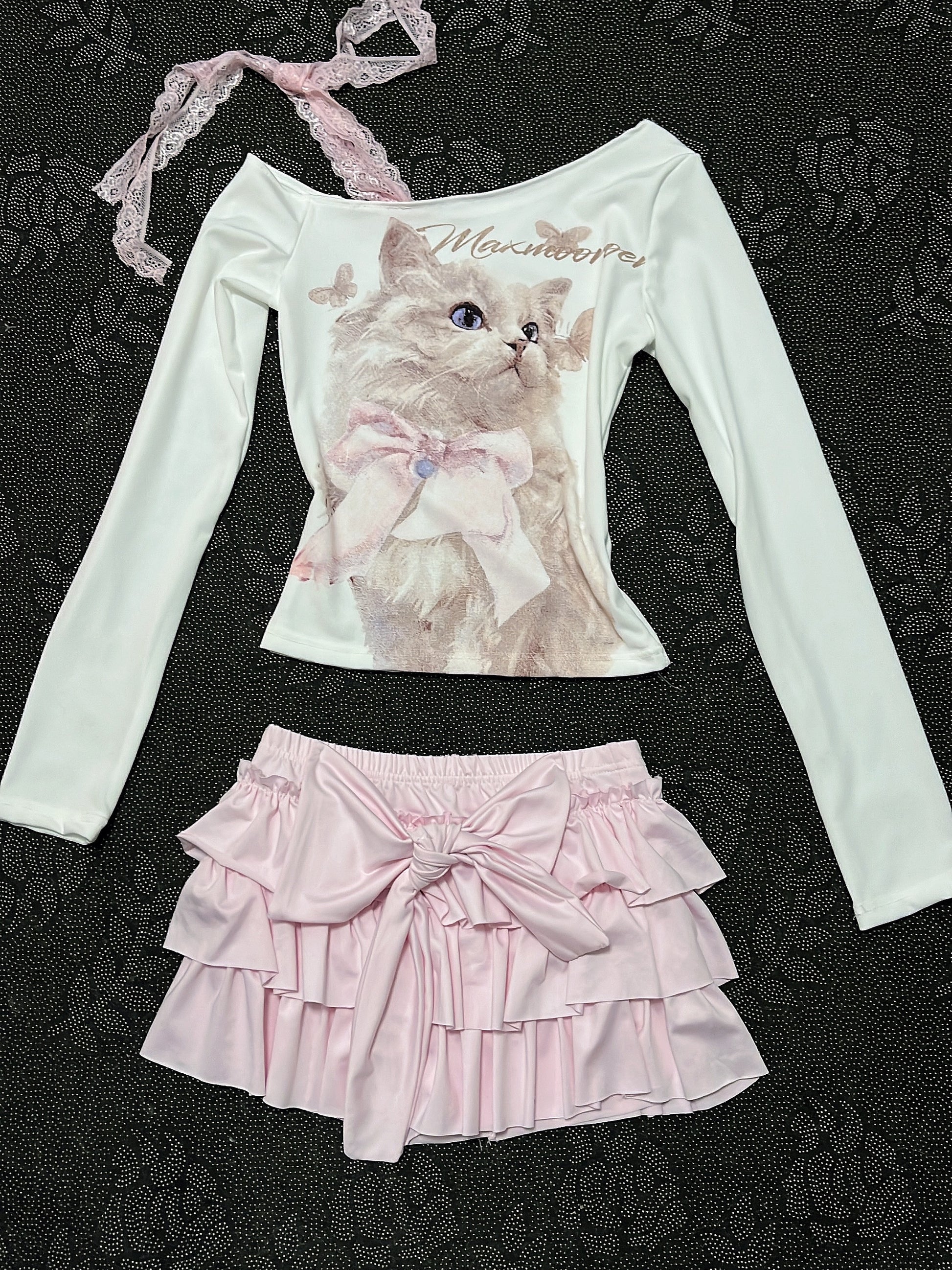 Cream long-sleeve cat top with lace strap; pale pink tiered ruffle skirt with bow