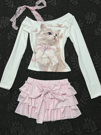 Cream long-sleeve cat top with lace strap; pale pink tiered ruffle skirt with bow