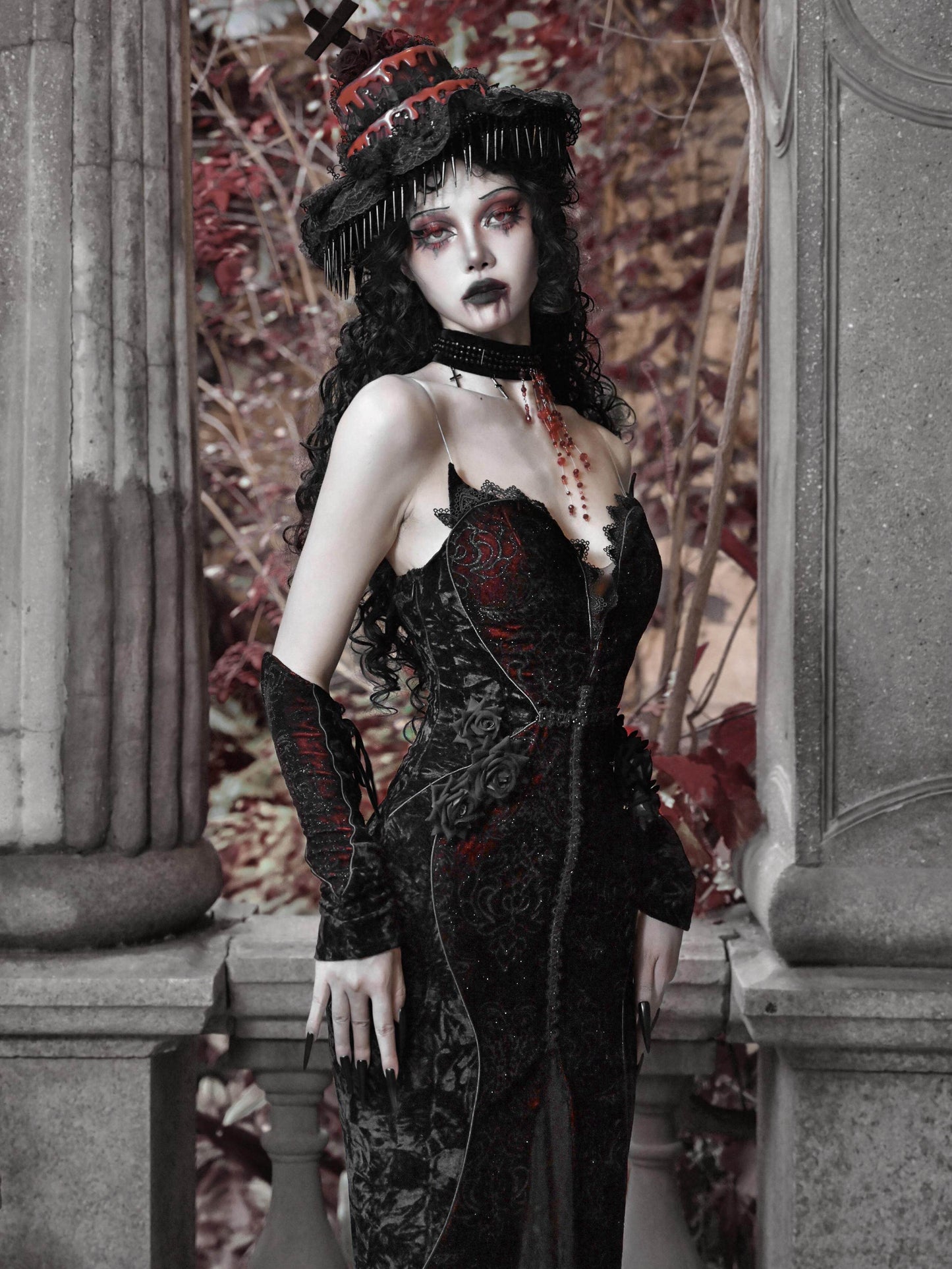 Black gothic corset maxi dress with red embroidery, lace trim, fitted skirt with flared hem.