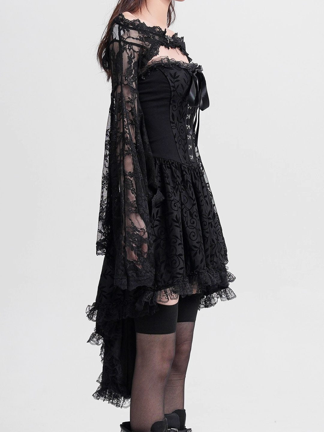 Black lace off-shoulder blouse with bow detail and layered asymmetrical skirt
