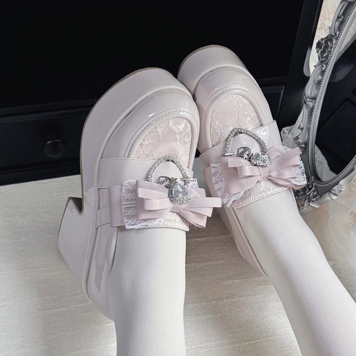 White lace platform loafers with ribbon bow and heart charm detail