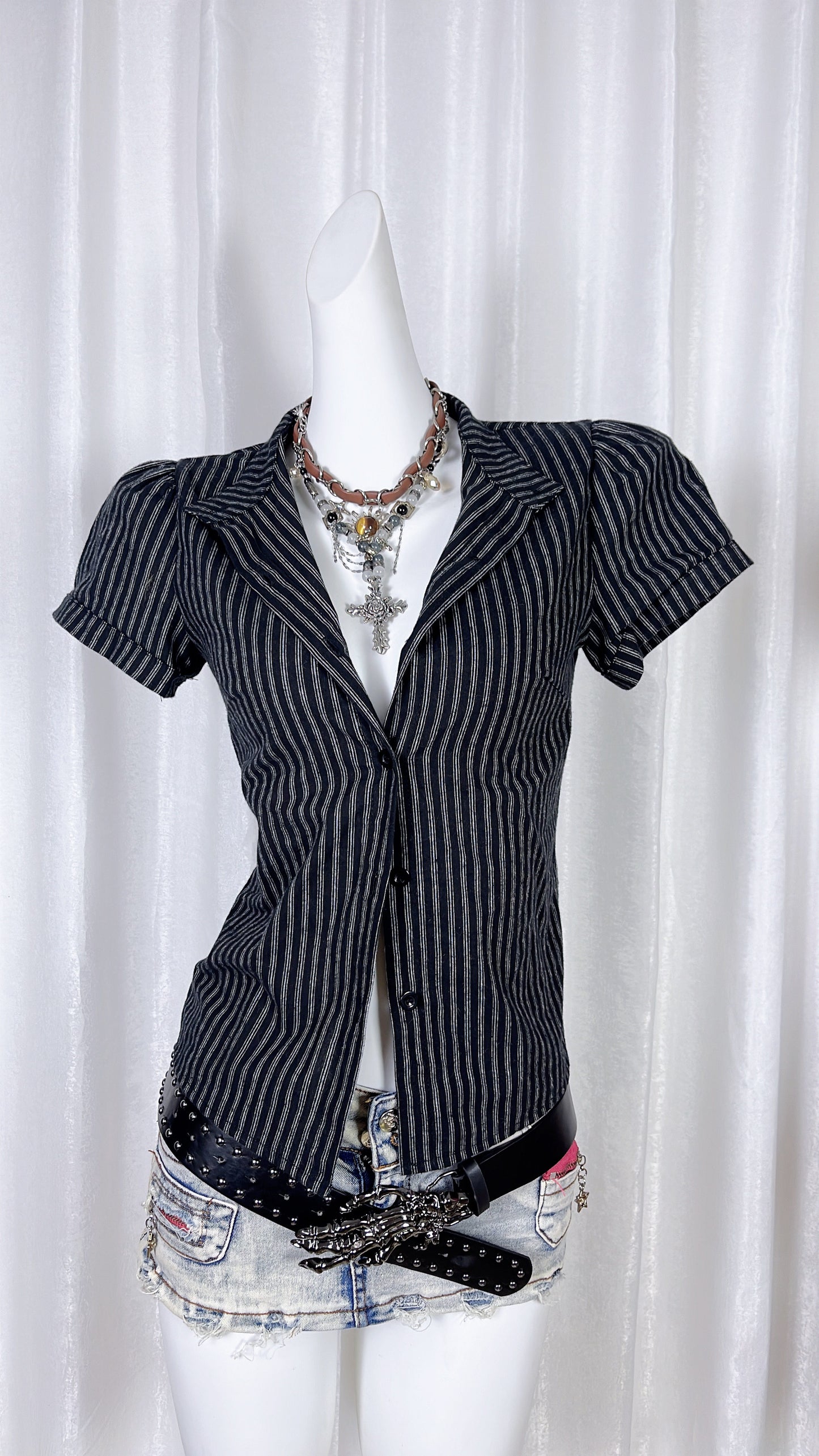 Navy pinstriped short-sleeve lapel shirt with front buttons and V-neck