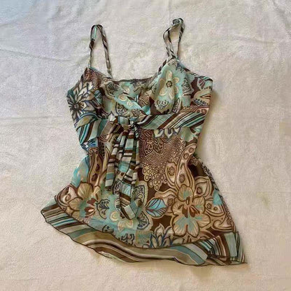 Floral patterned slip mini dress with green, teal, and brown tones and tie waist