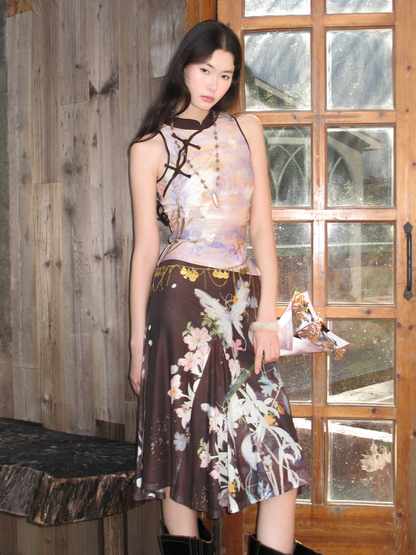 Sleeveless knit top and half skirt with black crisscross neck strap, floral butterfly print