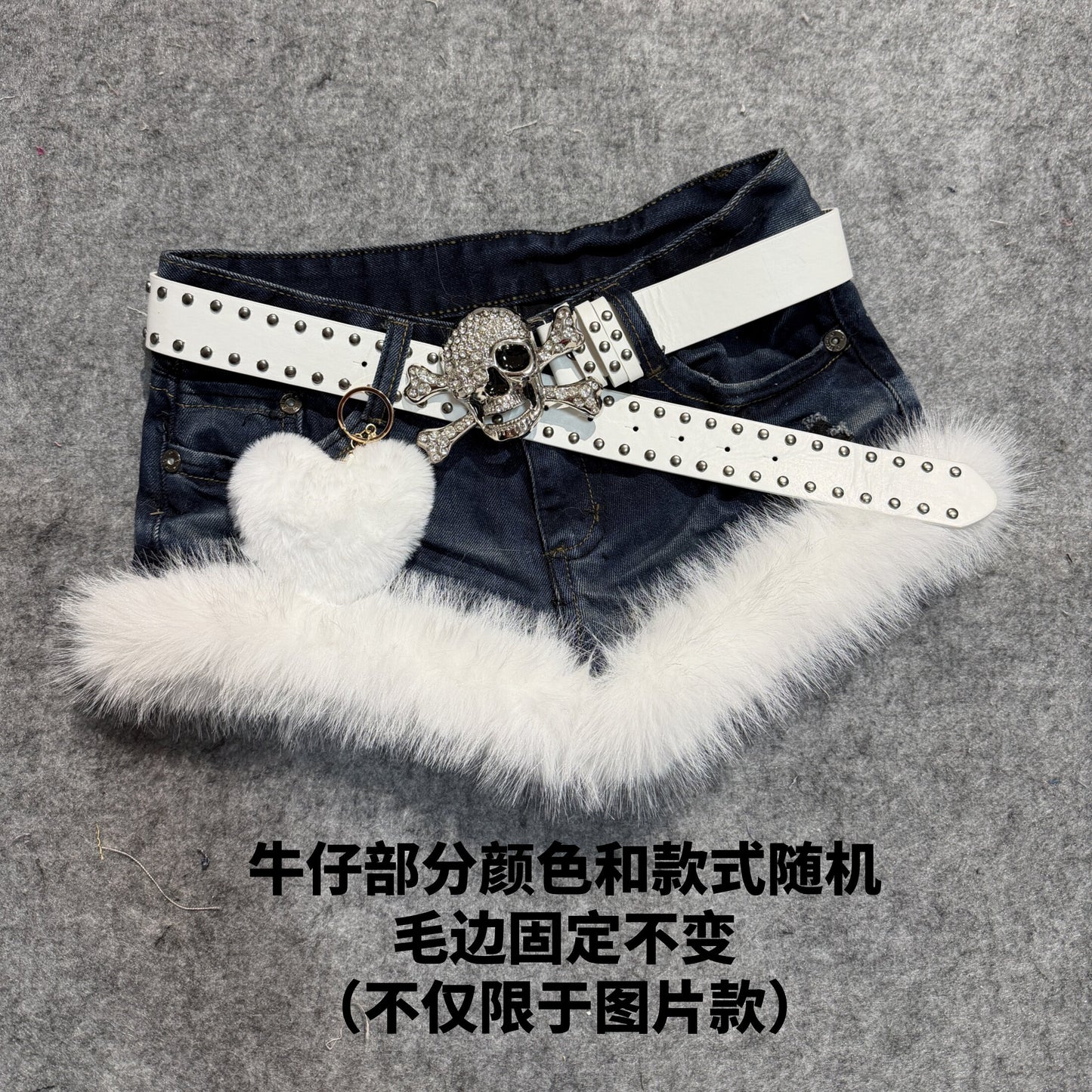 Dark blue denim shorts with white faux-fur trim and studded belt with cat plush