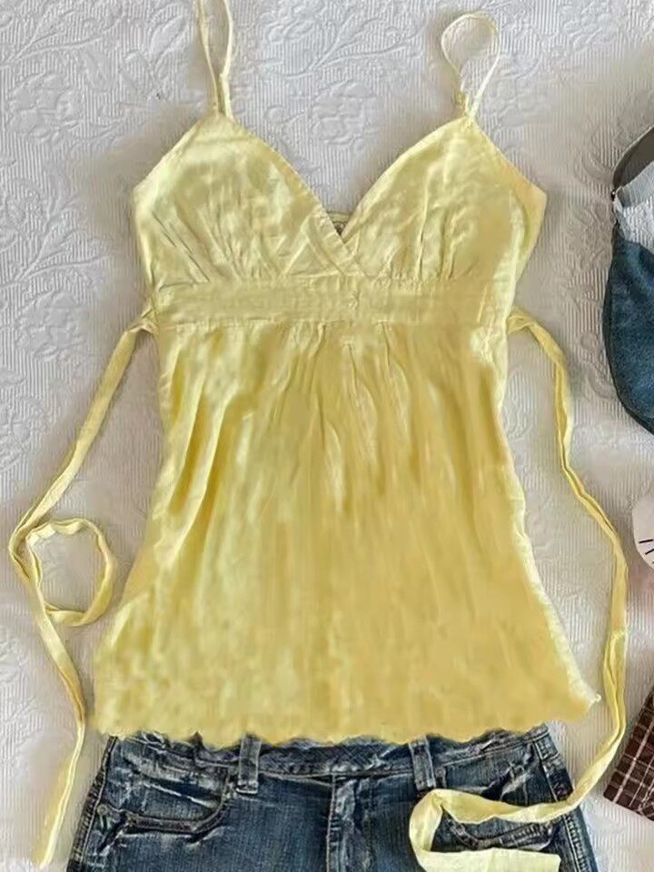 Yellow satin camisole top with V-neck and thin tie straps