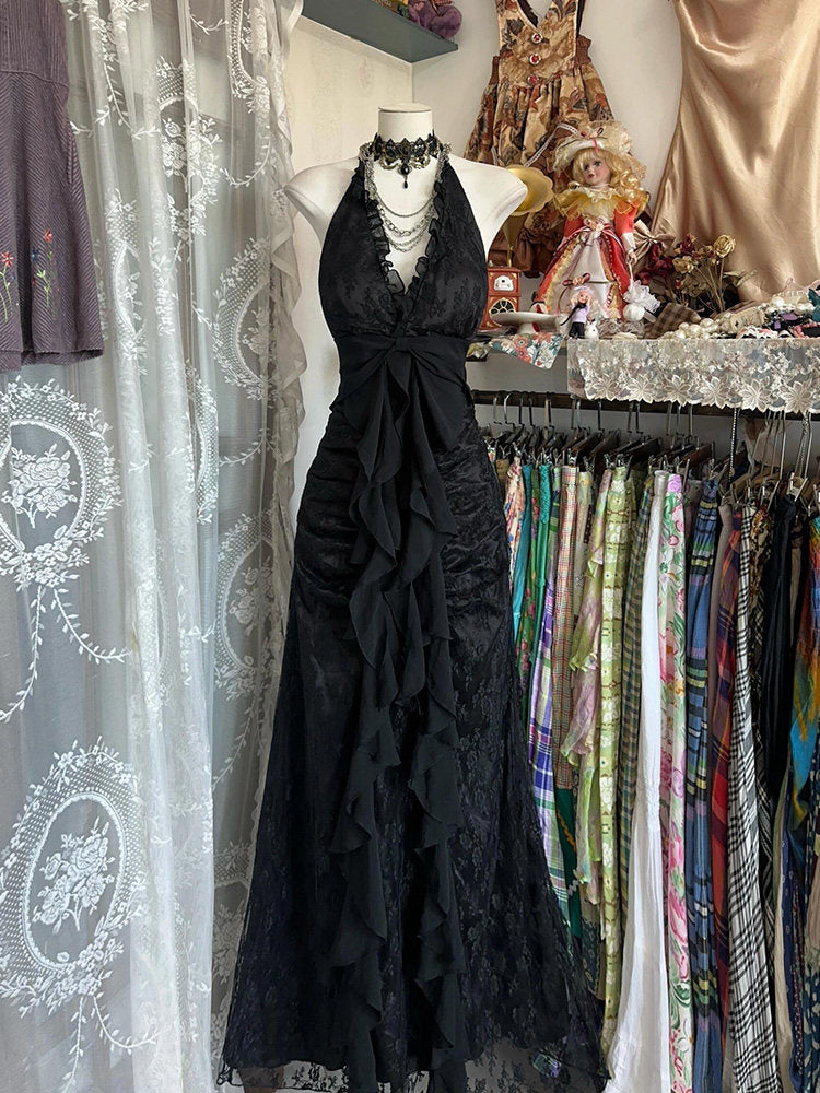 Black halterneck vintage dress with lace bodice, scalloped ruffles and tied waist bow