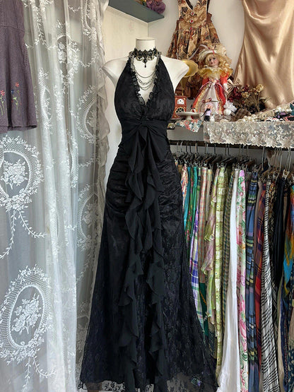 Black halterneck vintage dress with lace bodice, scalloped ruffles and tied waist bow