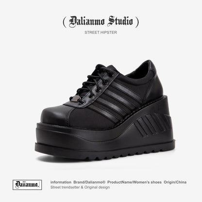 Black platform lace-up sneaker with three stripe panels and chunky tread sole