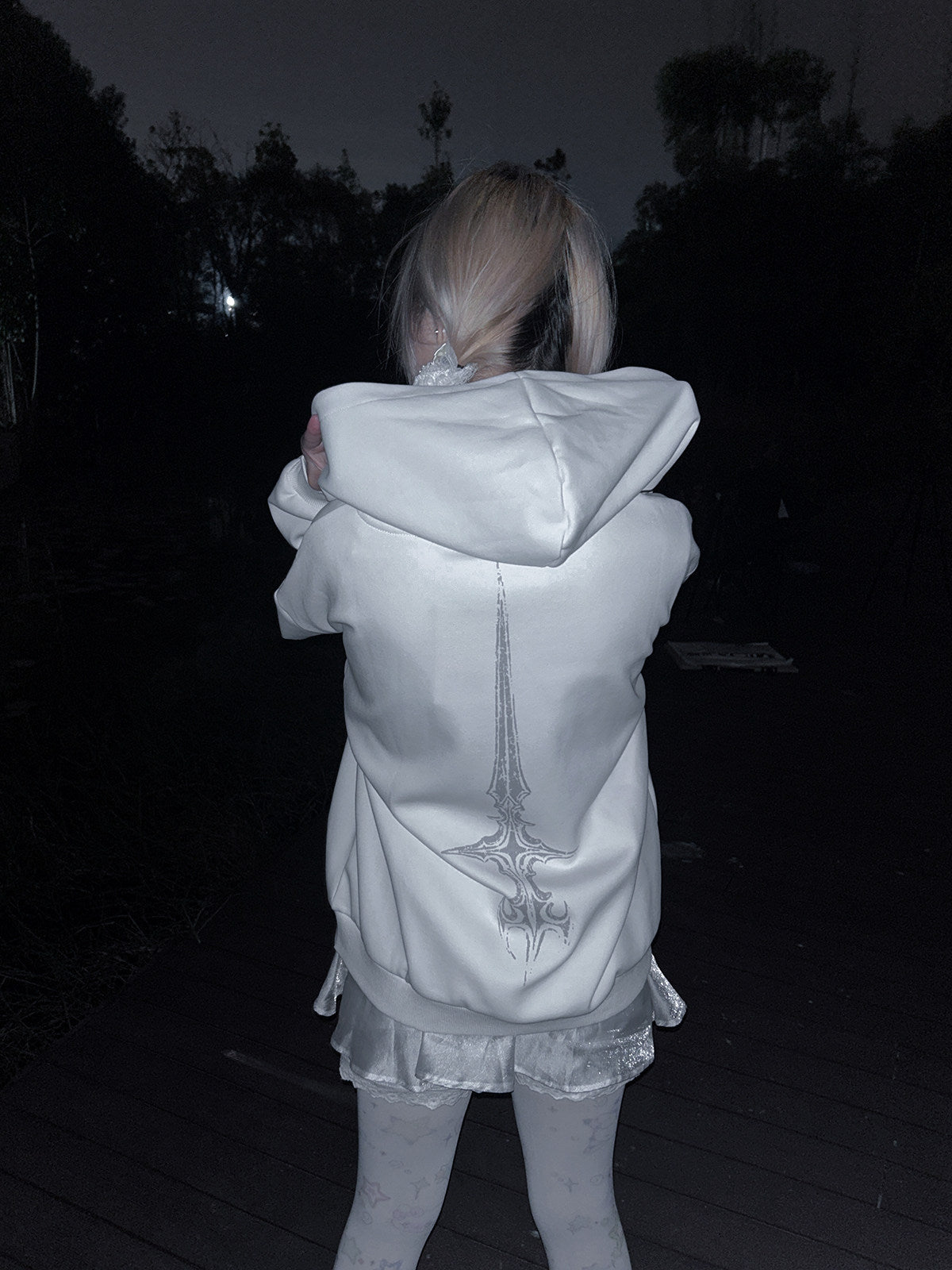 White hooded loose jacket showing back gothic cross graphic, zip-front