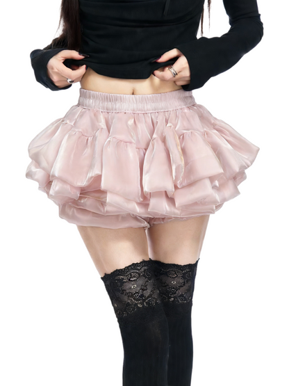Light pink tiered ruffle skirt with gathered elastic waistband and layered fabric