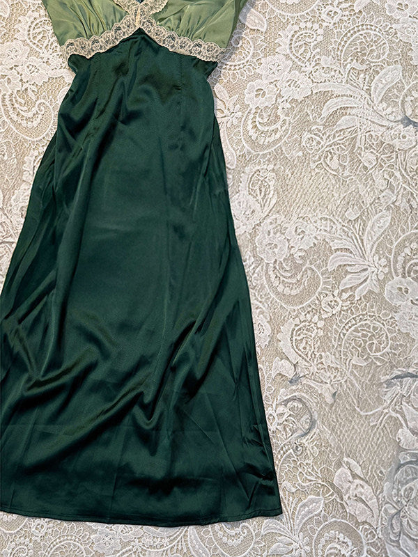 Dark green satin V-neck dress with lace-trimmed bodice and flowing gathered skirt