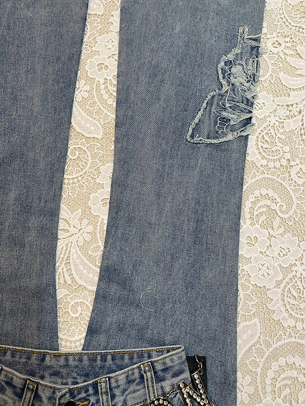 Light-blue micro-flare denim jeans with butterfly embroidery and embellished front waist