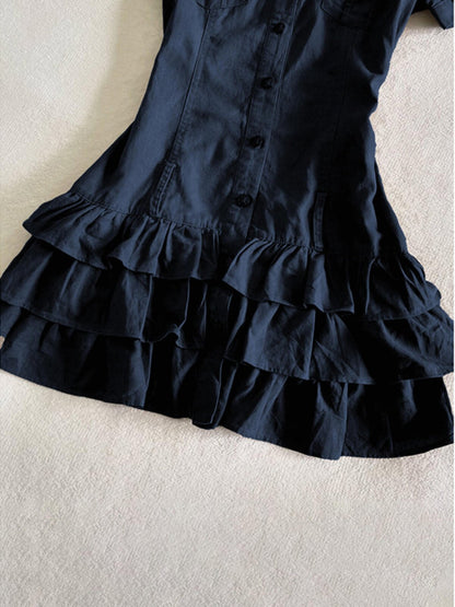 Dark blue tiered ruffle skirt hem on a button-front shirt dress