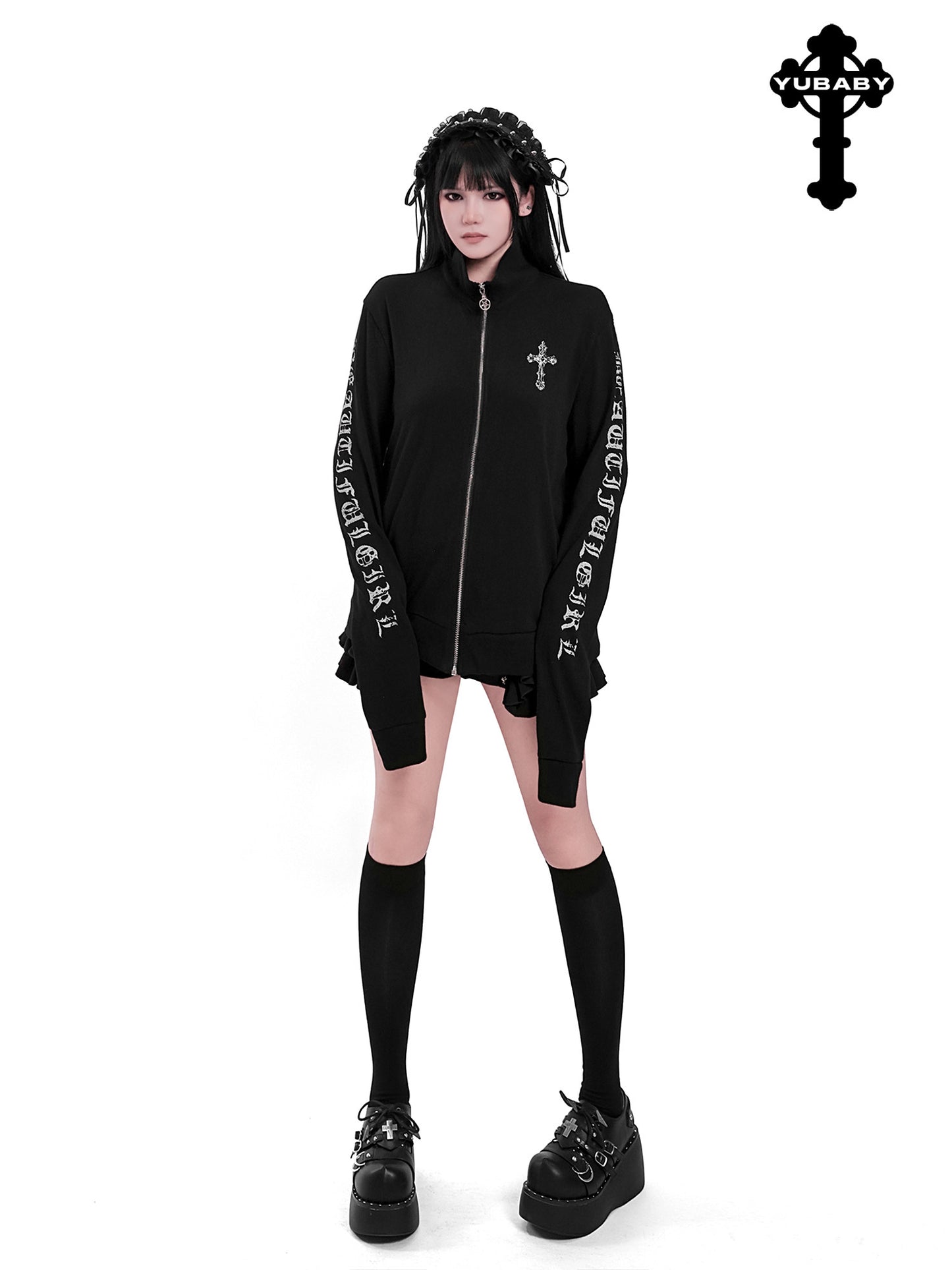 Black zip-up cardigan with front cross emblem and printed long sleeves, ruffled cuffs