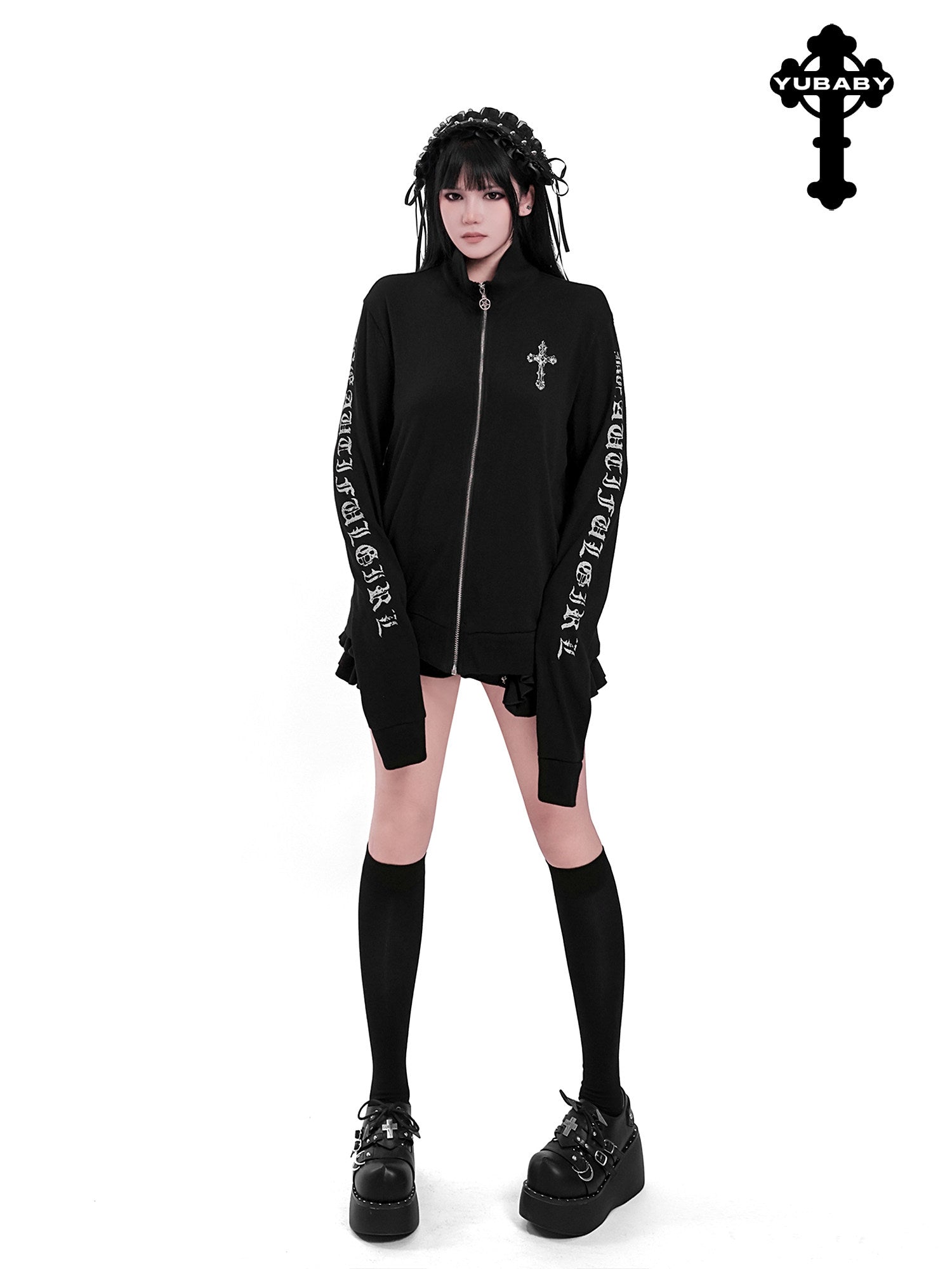 Black zip-up cardigan with front cross emblem and printed long sleeves, ruffled cuffs