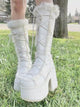 White platform ankle boots with lace-up front and fluffy faux-fur trim